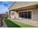 The backyard features a covered patio and synthetic grass for relaxing and entertaining at 161 Cabo Cruces Dr, Henderson, NV 89011