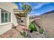 This backyard has a covered patio that is connected to the synthetic grass area at 161 Cabo Cruces Dr, Henderson, NV 89011