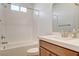 Bathroom with a shower-tub combo, tiled walls, and vanity with wood cabinets at 161 Cabo Cruces Dr, Henderson, NV 89011