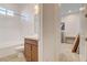 Bathroom with a shower-tub combo, tiled walls, and vanity with wood cabinets at 161 Cabo Cruces Dr, Henderson, NV 89011