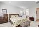 Cozy bedroom featuring a wood bed frame, white walls, carpeted floors, and natural light from the window at 161 Cabo Cruces Dr, Henderson, NV 89011