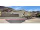 Modern home exterior with neutral tones, low-maintenance landscaping, and a two-car garage at 161 Cabo Cruces Dr, Henderson, NV 89011