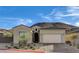 Charming single-story home featuring a tiled roof, two-car garage, and drought-tolerant landscaping at 161 Cabo Cruces Dr, Henderson, NV 89011