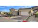 Inviting single-story home with a two-car garage, neutral color palette, and desert landscaping at 161 Cabo Cruces Dr, Henderson, NV 89011