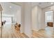 Hallway with wood flooring and views to living room and laundry room at 161 Cabo Cruces Dr, Henderson, NV 89011