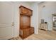 Hallway featuring custom mudroom storage with coat hooks, bench, and overhead cabinets for organization at 161 Cabo Cruces Dr, Henderson, NV 89011