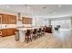 Open-concept kitchen featuring a center island, stainless steel appliances, and wood-look flooring at 161 Cabo Cruces Dr, Henderson, NV 89011