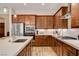 Beautiful kitchen featuring stainless steel appliances, white countertops, and wood cabinetry at 161 Cabo Cruces Dr, Henderson, NV 89011
