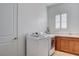 Bright laundry room featuring a washer, dryer, and cabinets for easy organization at 161 Cabo Cruces Dr, Henderson, NV 89011