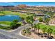 View of golf course and small lake in The Outlook community with desert landscaping at 161 Cabo Cruces Dr, Henderson, NV 89011