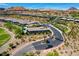 The Outlook community street view with mountain views and desert landscaping at 161 Cabo Cruces Dr, Henderson, NV 89011