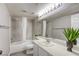 Well-lit bathroom features a shower-tub, a toilet and a wide vanity with a sink at 1833 Winners Cup Dr, Las Vegas, NV 89117