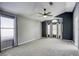 Spacious bedroom with neutral carpet, many windows for natural light and a ceiling fan at 1833 Winners Cup Dr, Las Vegas, NV 89117