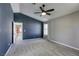 This bedroom offers vaulted ceilings, gray carpeting, natural light and a ceiling fan at 1833 Winners Cup Dr, Las Vegas, NV 89117