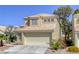 Front view of a two-story home with a terracotta roof, two-car garage, and desert landscaping at 1833 Winners Cup Dr, Las Vegas, NV 89117