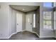 Bright foyer with a white front door, grey walls, hardwood floors, and a window with blinds at 1833 Winners Cup Dr, Las Vegas, NV 89117