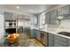 Sleek kitchen with stainless steel appliances, granite countertops, and ample cabinet space at 1833 Winners Cup Dr, Las Vegas, NV 89117