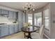 Eat-in kitchen boasts gray cabinets, and natural light from a large window at 1833 Winners Cup Dr, Las Vegas, NV 89117