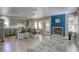 Open-concept kitchen and living room with granite countertops and a cozy fireplace at 1833 Winners Cup Dr, Las Vegas, NV 89117