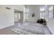 A spacious living room features grey hardwood floors, high ceilings, and plenty of natural light at 1833 Winners Cup Dr, Las Vegas, NV 89117