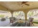 Inviting outdoor patio area with seating, ceiling fan, and a cozy ambiance at 1833 Winners Cup Dr, Las Vegas, NV 89117