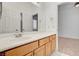 Bathroom vanity with light wood cabinets and a large mirror at 2150 Ponticello Dr, Henderson, NV 89052