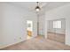 Bright bedroom featuring carpeted floors, ceiling fan and closet with mirrored doors at 2150 Ponticello Dr, Henderson, NV 89052