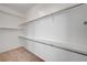Walk-in closet with white walls, carpeted floors, and shelving at 2150 Ponticello Dr, Henderson, NV 89052