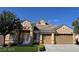 Inviting single-story home with a two-car garage, manicured lawn, and elegant double-door entry at 2150 Ponticello Dr, Henderson, NV 89052