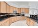 Well-equipped kitchen featuring light wood cabinets, granite countertops and stainless appliances at 2150 Ponticello Dr, Henderson, NV 89052