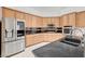 Kitchen with stainless steel appliances, oak cabinets, and black countertop at 2150 Ponticello Dr, Henderson, NV 89052
