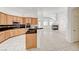 Spacious kitchen featuring light wood cabinets, black countertops, and an island at 2150 Ponticello Dr, Henderson, NV 89052