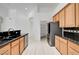 Open kitchen featuring light wood cabinets, granite countertops and stainless appliances at 2150 Ponticello Dr, Henderson, NV 89052
