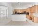 Bright kitchen with light wood cabinets, black countertops, and tile flooring at 2150 Ponticello Dr, Henderson, NV 89052