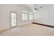 Bright living space featuring ceramic tile flooring, neutral walls, a ceiling fan, and a door to the patio at 2150 Ponticello Dr, Henderson, NV 89052