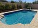 Sparkling blue pool and spa surrounded by a well-maintained backyard, perfect for relaxation and outdoor enjoyment at 2150 Ponticello Dr, Henderson, NV 89052