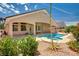 Inviting pool with connected spa, covered patio, and landscaped backyard at 2150 Ponticello Dr, Henderson, NV 89052