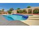 Sparkling pool with integrated spa, surrounded by landscaped backyard with tall privacy wall at 2150 Ponticello Dr, Henderson, NV 89052