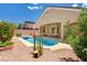 Beautiful pool area with desert landscaping, cacti, and a covered patio at 2150 Ponticello Dr, Henderson, NV 89052
