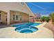 Relaxing in-ground spa with backyard views and covered patio at 2150 Ponticello Dr, Henderson, NV 89052