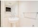 Elegant powder room with pedestal sink, modern fixtures, and a large mirror at 222 Karen Ave # 2506, Las Vegas, NV 89109