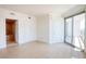 Bright bedroom featuring neutral decor, tile floors, and access to a bathroom and balcony at 222 Karen Ave # 2506, Las Vegas, NV 89109