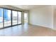 Bright, spacious living room featuring tile flooring, a sliding glass door to the balcony, and neutral decor at 222 Karen Ave # 2506, Las Vegas, NV 89109
