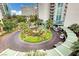 Grand entrance with circular driveway, lush landscaping, and porte-cochère at 222 Karen Ave # 601, Las Vegas, NV 89109