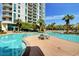 Gorgeous swimming pool with ample lounge chairs and beautiful landscaping surrounded by tropical palm trees at 222 Karen Ave # 601, Las Vegas, NV 89109