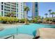 Serene pool area with a waterfall feature, swaying palm trees, and elegant high-rise buildings at 222 Karen Ave # 601, Las Vegas, NV 89109