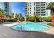 Luxurious swimming pool with palm trees and lush landscaping, a perfect oasis for relaxation and recreation at 222 Karen Ave # 601, Las Vegas, NV 89109