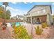 View of backyard featuring a patio, pool, and lush landscaping in a well-maintained outdoor space at 2250 Tedesca Dr, Henderson, NV 89052