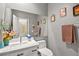 Well lit half bath with a modern white vanity and decorative wall art at 2250 Tedesca Dr, Henderson, NV 89052