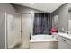 Bright bathroom features a tub under a window, and separate glass shower at 2250 Tedesca Dr, Henderson, NV 89052